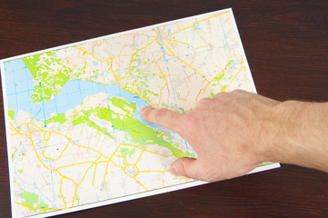 A hand who pointing a map