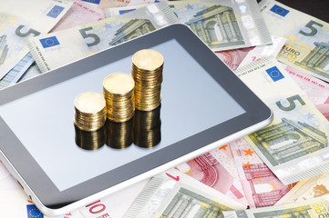 rows of gold stack coins, tablet and euros