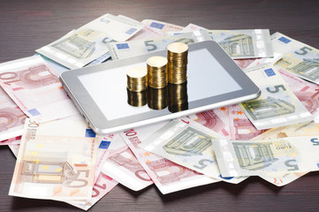 rows of gold stack coins, tablet and euros
