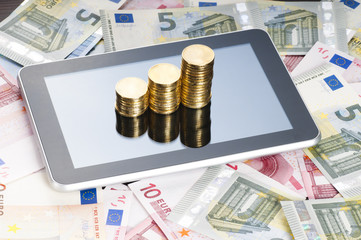 rows of gold stack coins, tablet and euros