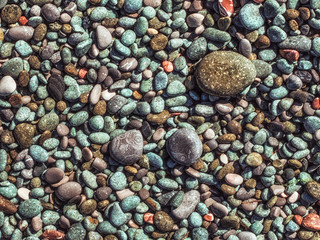 Wet pebbles on the beach.