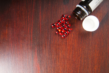 red drugs and pills on the table