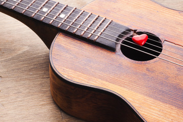 Fototapeta premium Valentines Day background with hearts on vintage guitar