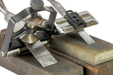 Chisels Clamped in Angle Guide Jigs  on Grinding Whetstones