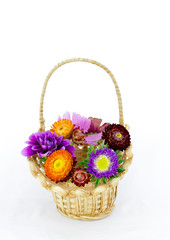 Fototapeta na wymiar summer coloeful flowers bouquet in wicket basket isolated