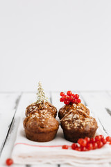 Christmas Cupcakes on White Wooden Table against White Background