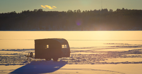 Ice Fishing Hut on Frozen Lake 