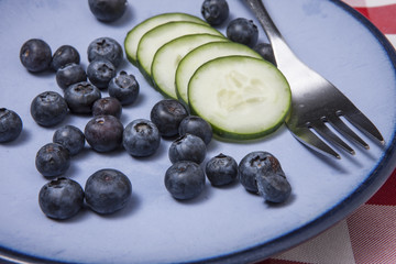 Macro image of blueberries and cucumbers.