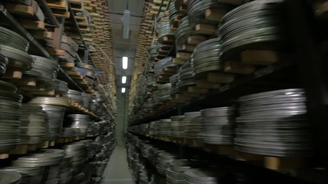 Vintage reel, video or audio tapes in a old media archives shelfs. 4K.