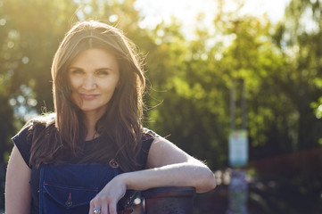 Naklejka premium beautiful girl in a summer park in the sun