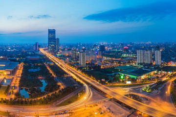 Naklejka na ściany i meble Aerial skyline view of Hanoi cityscape at twilight. Thang Long freeway and Pham Hung street