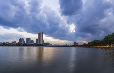 Linh Dam lake at sunset with cloudy sky. Hanoi cityscape