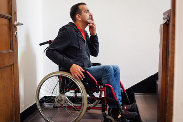 Man In Wheelchair Having Trouble With Stairs