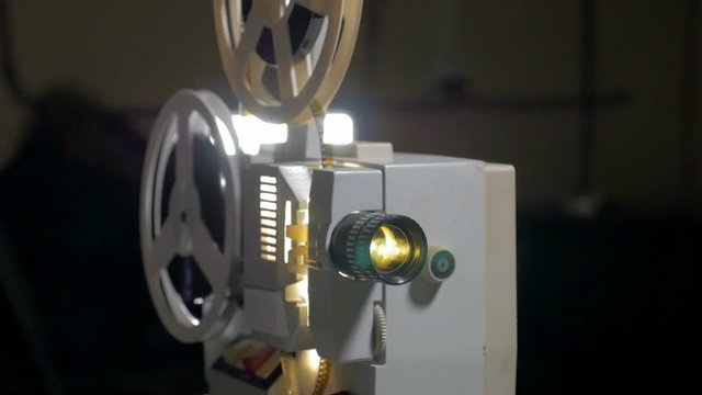 worker switch on antique Film Projector. HD.