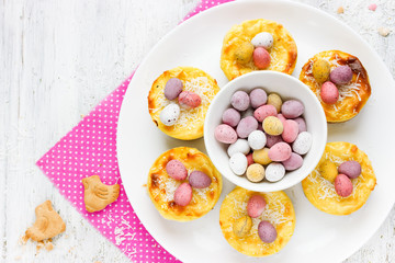 Easter nest cakes with colorful chocolate candy eggs