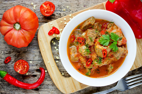 Meat goulash , pork stew with red bell pepper and tomatoes sauce