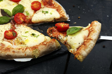 Hot true PEPPERONI ITALIAN PIZZA with salami and cheese. TOP VIEW Tasty traditional pepperoni pizza on board on wooden table with decoration
