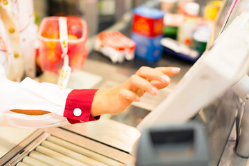 Sales Clerk At A Cash Register In The Supermarket