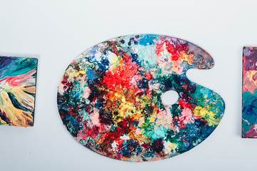 The artist's palette stained with paint. On a white background, nobody