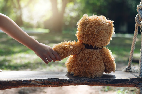 girl hold hand Teddy bear