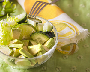 Bowl of green salad of cucumber, escarole and avocado, delicious