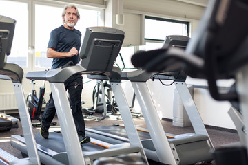 Fototapeta premium Senior Caucasian Man Working Out At The Gym