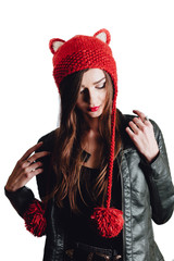 Pretty young woman wearing a hand knitted red hat on white background. Isolated. Beautiful girl in with Ear flap.