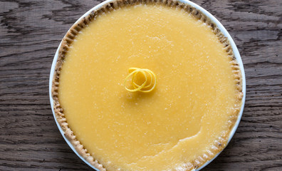 Lemon tart on the wooden background