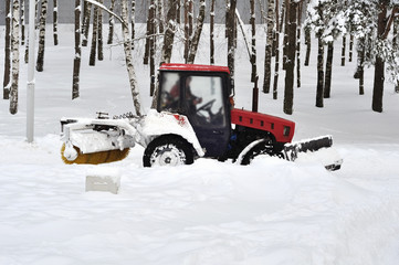 Tractor clears snow in the park