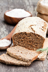 Fototapeta na wymiar Homemade rye bread with wholemeal bread flour on wooden table