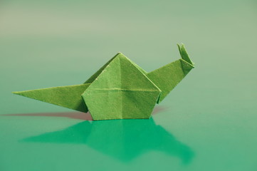 Paper origami snail isolated on a colorful background