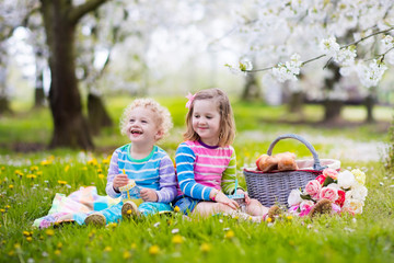 Kids having picnic in blooming garden