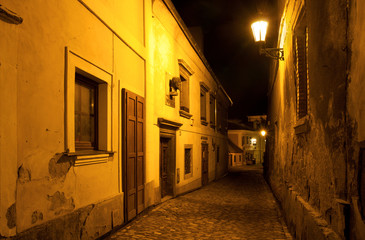 Fototapeta na wymiar Empty street at night in the town, Kutna Hora, Czech Republic