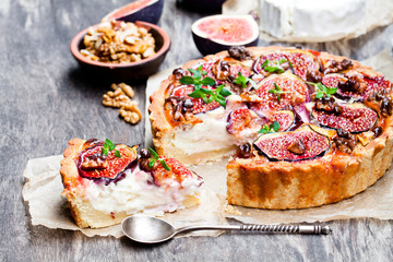 Delicious  tart with fresh figs and goat cheese on rustic wooden