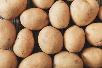 Fototapeta na wymiar Close up of ripe raw potatoes. Top view