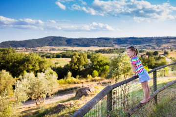 Fototapeta na wymiar Little girl watching landscape in Italy