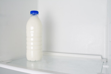 Milk in an empty fridge.