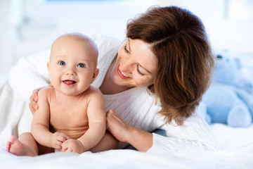 Baby and mother at home. Mom and child.