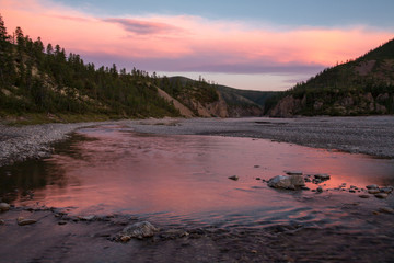 Red light from the sunset in the valley. River Omulevka. Yakutia. Russia.