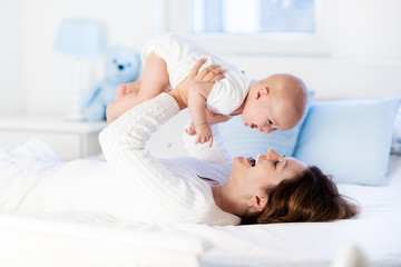 Baby and mother at home. Mom and child.