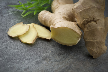 Ginger root slices close up on gray background