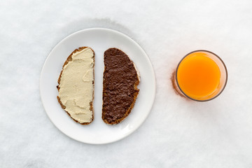 breakfast plate with bread (hazelnut spread, hummus) and multivi