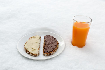 breakfast plate with bread (hazelnut spread, hummus) and multivi