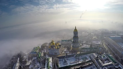Fotobehang Kiev aerial view Kiev-Pechersk Lavra in winter fog