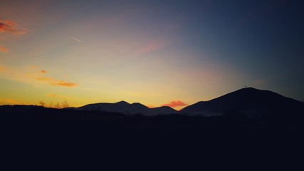 Scenic background of the view of orange sky with the mountain silhoutte