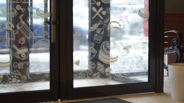 Customer entering store on a snowy winter day, holiday shopping