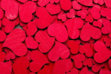 Red hearts on the wooden background.