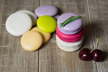Set of colorful macaroon dessert on wooden tabletop.