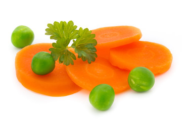 Carrot slice, green peas, isolated on white.