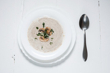 Bowl of creamy mushroom soup on wood